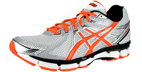 silver athletic shoe with bright orange accents and white sole with bright orange trim in the bottom